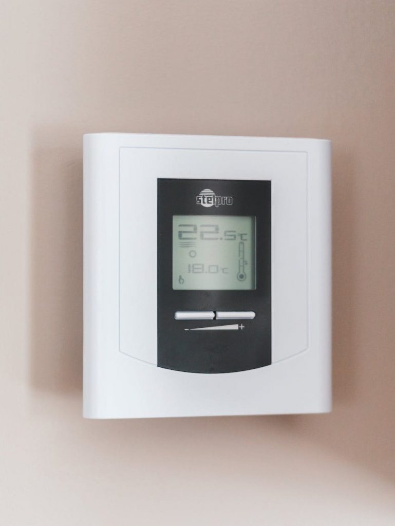 white thermostat hanging on the wall